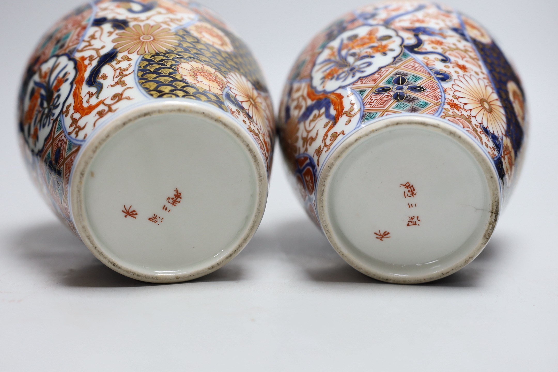 A pair of Japanese Fukugawa Imari bottle vases, signed. 19cm tall